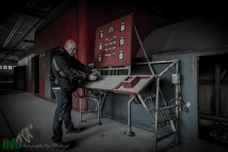 Artistieke erotische fotoshoot in een verlaten fabriek met een rauwe urbex sfeer.